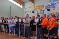 Policjanci - piłkarze stojący w szeregu na hali sportowej