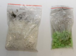 Zdjęcie przedstawia torebkę foliową z białym proszkiem i torebkę foliową z zielonymi tabletkami