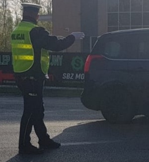 policjant prowadzi ręczną regulację ruchem drogowym