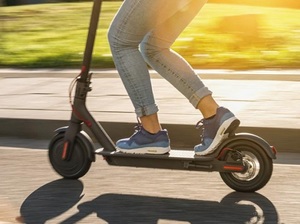 osoba porusza się na elektrycznej hulajnodze