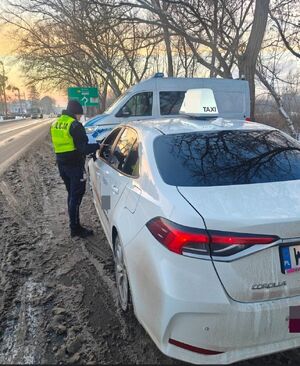 policjantka kontroluje kierowcę taksówki