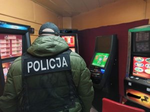 policjant stojący na wprost do automatów do gier
