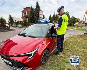 policjant kontroluje taksówkę