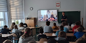 policjant rozmawiając z klasą w szkole w tle film profilaktyczny