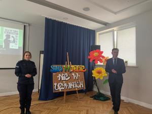 policjantka i męzczyzna w garniturze na spotkaniu z młodzieżą