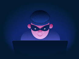 grafika przedstawia postać w ciemnej czapce z założoną na oczy opaską z wyciętymi dziurkami, postać siedzi przed otwartym laptopem