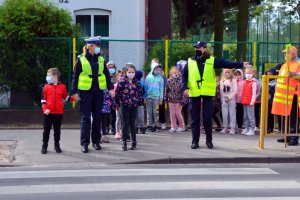 policjantki prowadzą spotkane z dziećmi w pobliżu przejście dla pieszych