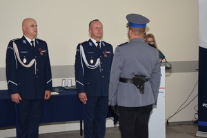Policjant stoi naprzeciwko dwóch policjantów