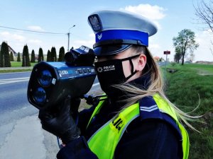 Policjantka w trakcie pomiaru prędkości.